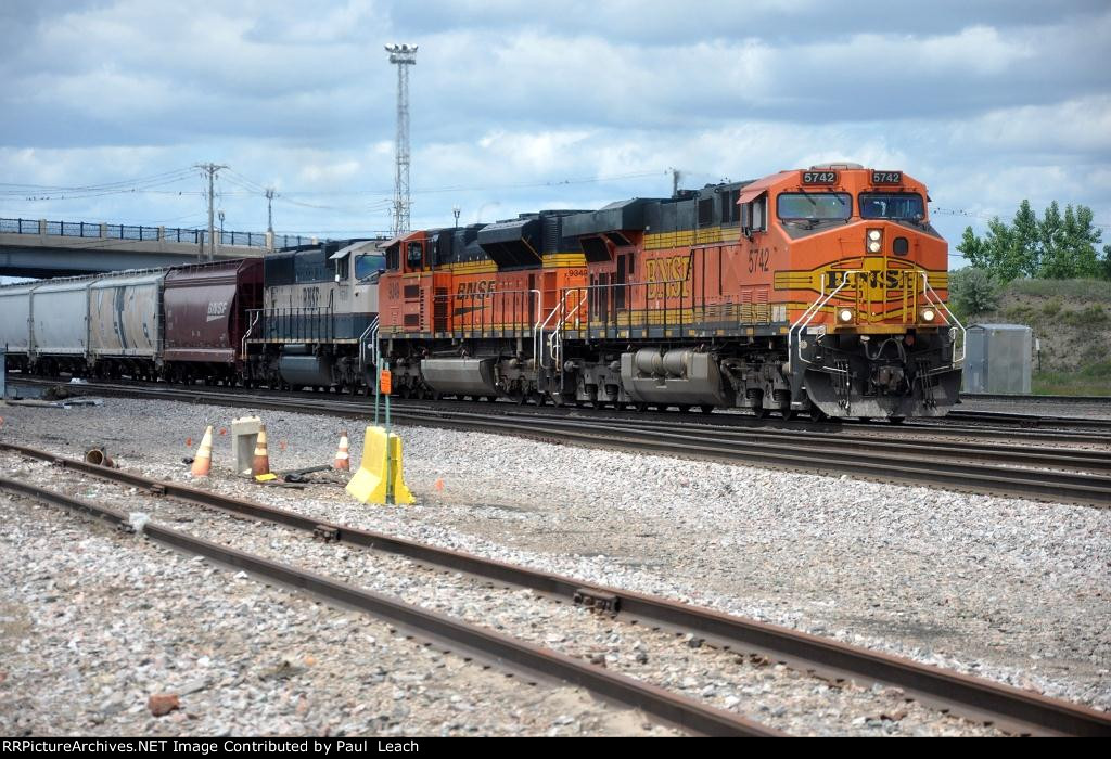 Grain train rolls east past University